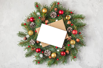 Fototapeta na wymiar Christmas greeting card with Christmas wreath with holiday decoration on concrete background. flat lay. top view