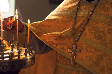 burning candle in his hand, a prayer in the church. The Christian.