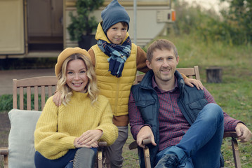 Beautiful European family on camper. They enjoying their pastime together smiling and looking to camera. - 306766360