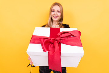 portrait of beautiful smiling girl with gift box