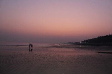 silhouette of man on beach at sunset