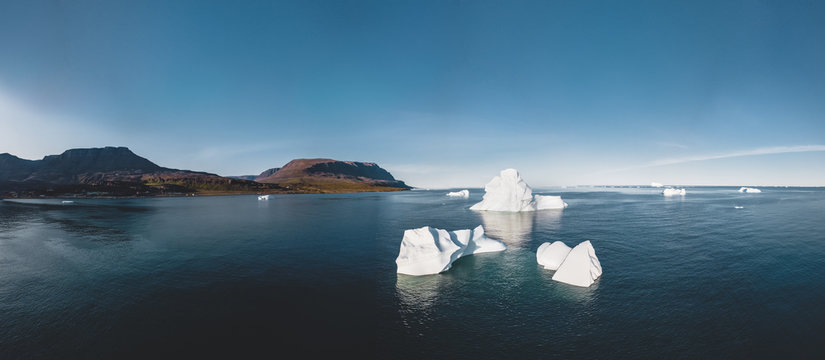Iceberg and ice from glacier in arctic nature landscape in Ilulissat,Greenland. Aerial drone photo of icebergs in Ilulissat icefjord. Affected by climate change and global warming.
