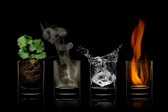 Four elements concept in glasses. earth, air, water, fire.