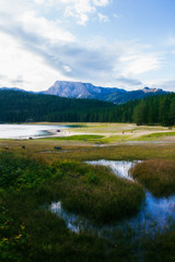 Different views of the glacial Black lake (Crno jezero), forest and mountains around in the national park Durmitor in Montenegro, Europe