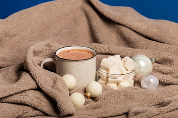 Mug of cocoa with warm blanket. Winter mood.