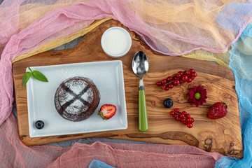 Close up Photograph of a chocolate souffle. Chocolate fondant lava cake with strawberries.