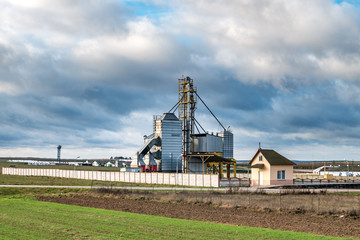 Fototapeta na wymiar Granary elevator. agro-processing and manufacturing plant for processing and silver silos for drying cleaning and storage of agricultural products, flour, cereals and grain.
