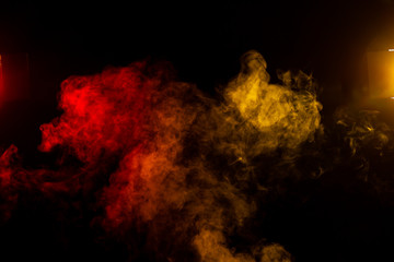 red and yellow smoke clouds with stage lights on black background