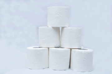 White toilet paper on white background. A few rolls.