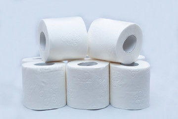 White toilet paper on white background. A few rolls.