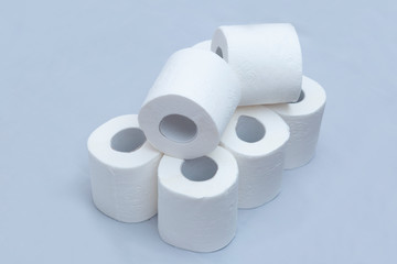 White toilet paper on white background. A few rolls.