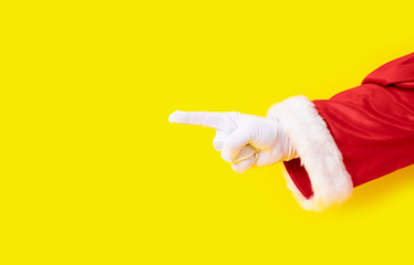 Santa Claus glove hand yellow background one red suit copy space