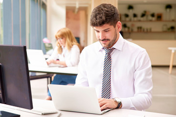 Businessman working on laptop at office desk