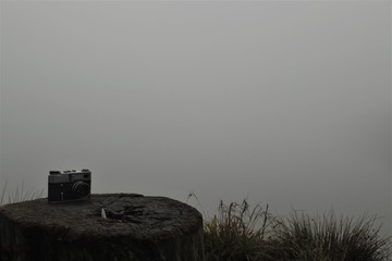  old camera on a stump in the fog