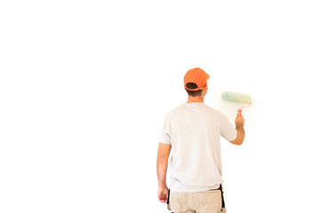 Young man painting wall in the apartment