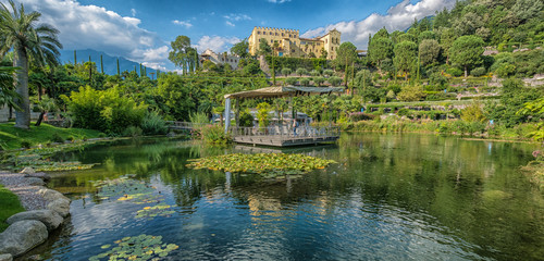 Fototapeta na wymiar Botanical gardens with view of Trauttmansdorff Castle - Meran, Trentino Alto Adige, northern Italy, august 2019.