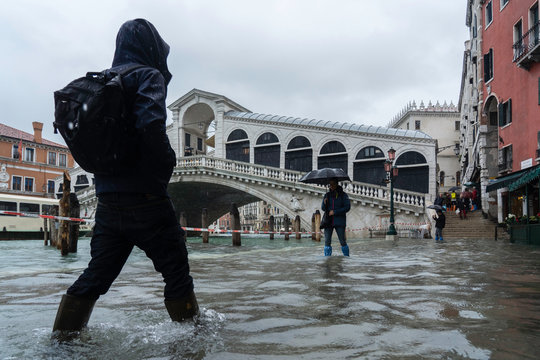 VENICE, ITALY - November 24, 2019: flood (acqua alta) in Venice, Italy. Venice high water. Tourists in Venice during a flood in Venice. Natural disaster. drama during the flood