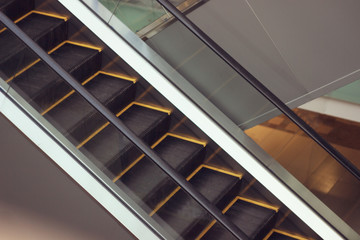 Escalator in Community Mall, Shopping Center. Moving up staircase. electric escalator. Close up to escalators. Close up floor platform. yellow bands. metal line steel. yellow gray steel line.