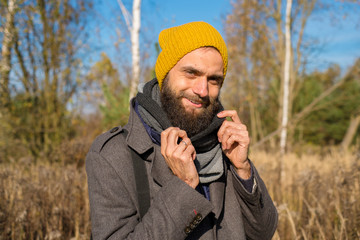 Man in autumn in park in a hat. Man with beard in autumn or fall. hipster photo. 