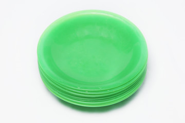 empty stack of green plastic plates on white background