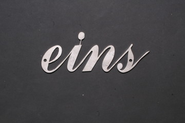 Fototapeta premium number in handwriting made of stainless steel, house number,