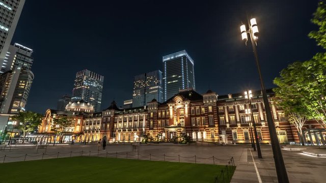 4K UHD time-lapse of car traffic at Tokyo Station at night with Japanese people crossing roads. Tokyo tourist attraction, Japan tourism, Asian city life, or Asia transportation concept