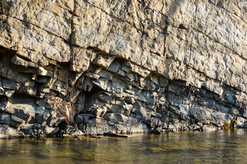 Rocky coast of the river. Landscape of countryside river