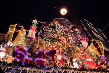 Christmas outside street decoration with lights, deer, presents, elves. Selective focus.
