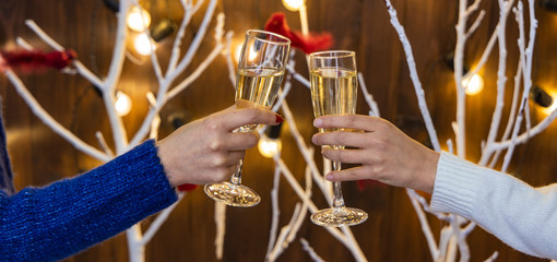 hand glass of champagne corporate party celebration holidays wallpaper poster picture with garland illumination festive background 