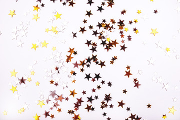 Golden and silver stars on white background. Flat lay, top view.