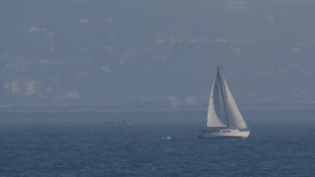 Sailboat in the Pacific Ocean on a hazy, hot day