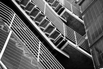 Fototapeta premium Underneath Staircase on outside of building -black and white