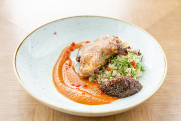 Plate Duck leg su-vide, with bulgur and onion marmalade. Barbecue restaurant menu, a series of photos of different meats