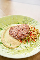 Plate with Beefsteak marbled beef, served with bulgur and smoked onion cream. Barbecue restaurant menu, a series of photos of different meats