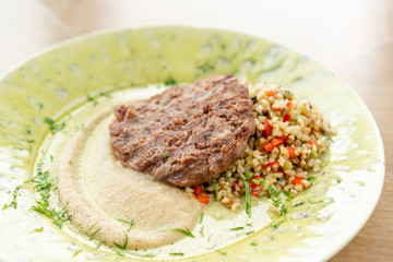 Plate with Beefsteak marbled beef, served with bulgur and smoked onion cream. Barbecue restaurant menu, a series of photos of different meats