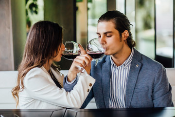 Portrait of young couple drinking red wine on broodershaft and enjoying this time.