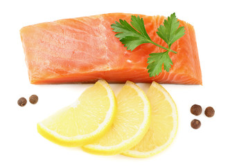 Red fish. Raw salmon fillet with parsley, peppercorns and lemon isolate on white background. Top view
