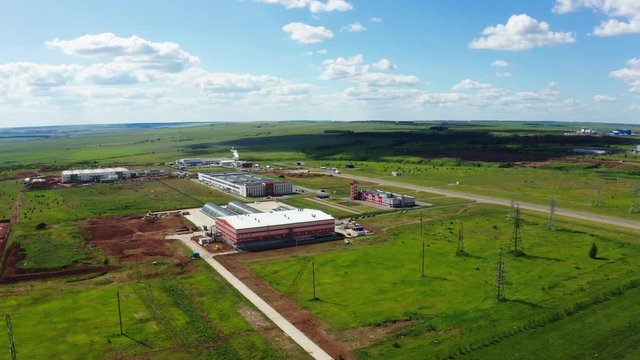 production plant buildings among fields aerial panorama