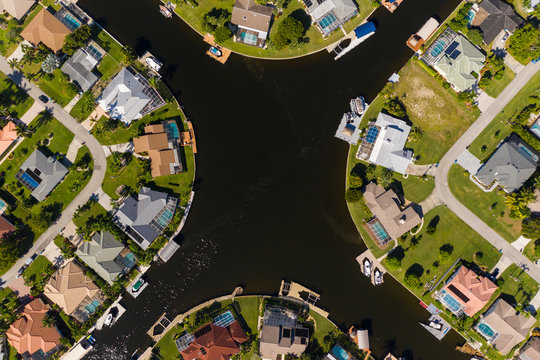 Aerial photos of Cape Coral residence houses and canals with Fort Myers in the background