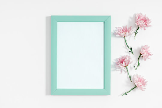 Beautiful flowers composition. Photo frame and pink flowers on white background. Valentines Day, Easter, Happy Women's Day, Mother's day. Flat lay, top view, copy space