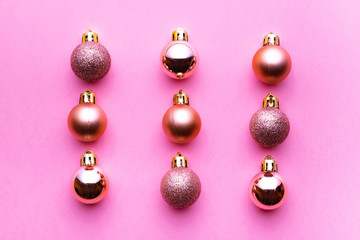 Xmas balls isolated on pink background. Christmas bubble pattern decoration. Flat lay. Winter concept