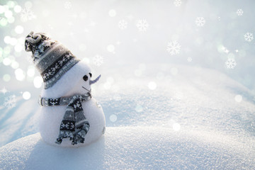 Cheerful snowman in winter landscape in light gray tones.