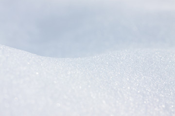 Fototapeta na wymiar Pure white snow close-up. Blank for design. Beautiful snow background texture