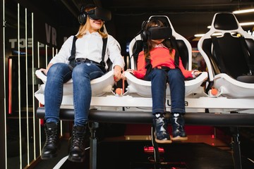 Mother and child playing together with virtual reality headsets