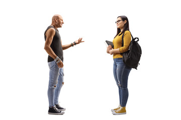 Male hipster talking to a female student holding books