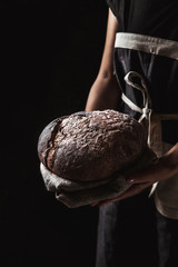 rustic bread in baker hand, healthy food