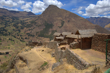 buildings in the andes mountains on a sunny day with blue sky and white clouds