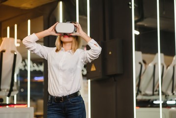 Young woman using glasses of virtual reality. VR, future, gadgets, technology concept