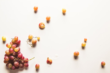 Ripe red grape with leaves isolated on white