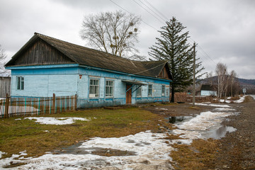 Russian village. Old residential wooden house in a Russian village in spring. Village hut without a fence.